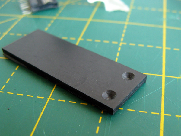 Backing support piece to hold the connector against the serial port contacts
