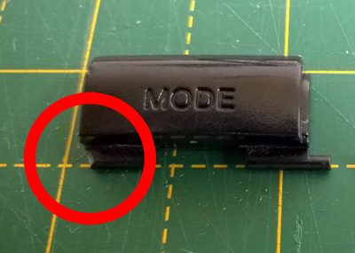 Button with missing plastic peg marked