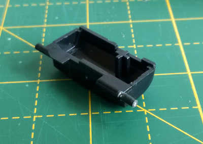 The peg glued to the broken button with the paper clip